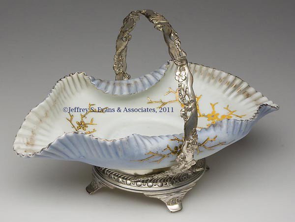 VICTORIAN DECORATED-OPAL CELERY (OMN) / BRIDE'S BA: VICTORIAN DECORATED-OPAL CELERY (OMN) / BRIDE'S BASKET, fired-on shaded blue, polychrome and gilt decoration, tooled and crimped rim, polished pontil mark, fitted in a Pairpoint quadruple-plate stand.