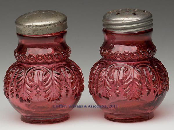 NORTHWOOD'S NO. 263 / LEAF UMBRELLA PAIR OF SALT A: NORTHWOOD'S NO. 263 / LEAF UMBRELLA PAIR OF SALT AND PEPPER SHAKERS, Ruby/cranberry, period lids. Northwood Glass Co. Fourth quarter 19th century. 3 1/8" HOA. Provenance: Personal collection of Judith