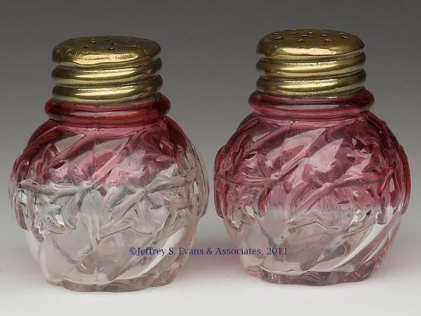 ROYAL IVY PAIR OF SALT AND PEPPER SHAKERS: ROYAL IVY PAIR OF SALT AND PEPPER SHAKERS, rubina, period lids. Northwood Glass Co. Fourth quarter 19th century. 2 5/8" HOA. Provenance: Personal collection of Judith (Judy) Cronin, Orleans, MA.