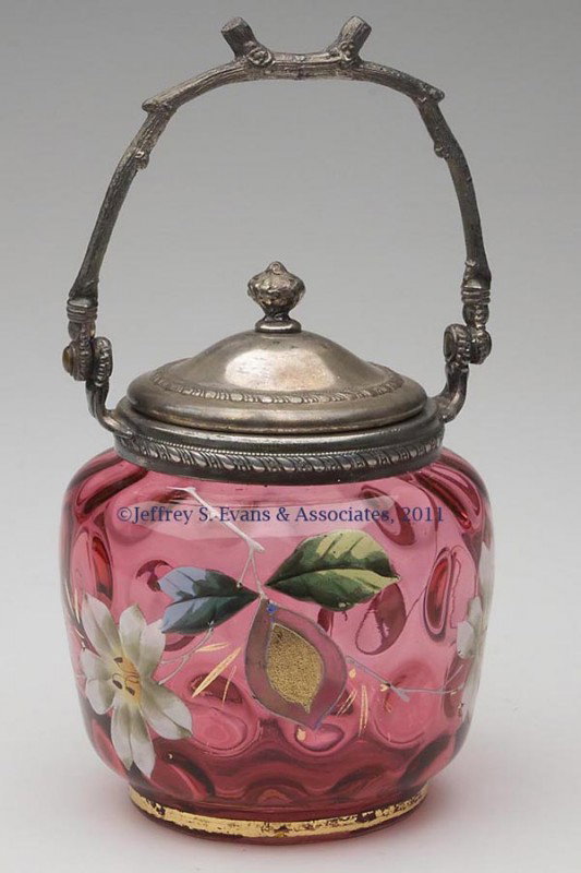 INVERTED THUMBPRINT MARMALADE / BON-BON JAR: INVERTED THUMBPRINT MARMALADE / BON-BON JAR, cranberry with polychrome and gilt floral decoration, integral Pairpoint silver-plate fittings. Late 19th/early 20th century. 7 1/2" HOA, 3 7/8" H jar, 4 1
