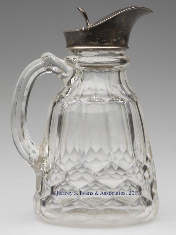 NEW YORK (OMN) / HONEYCOMB PINT MOLASSES JUG: NEW YORK (OMN) / HONEYCOMB PINT MOLASSES JUG, colorless flint, with an inappropriate sterling silver lid, monogrammed "R". New England Glass Co. Third quarter 19th century. 6 1/4" HOA. Literature: Aco