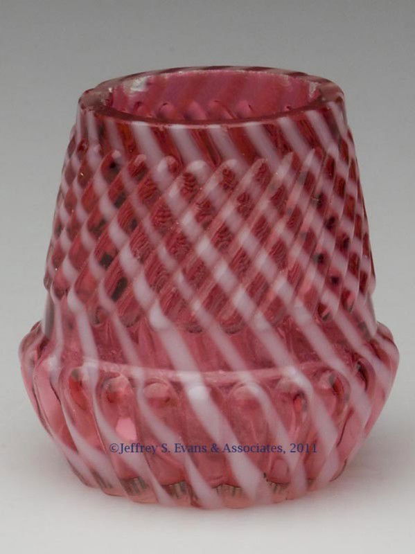 CHRYSANTHEMUM BASE SWIRL TOOTHPICK HOLDER: CHRYSANTHEMUM BASE SWIRL TOOTHPICK HOLDER, cranberry opalescent, factory-polished rim. Late 19th/early 20th century. 2" H. Provenance: From a Pennsylvania collection.