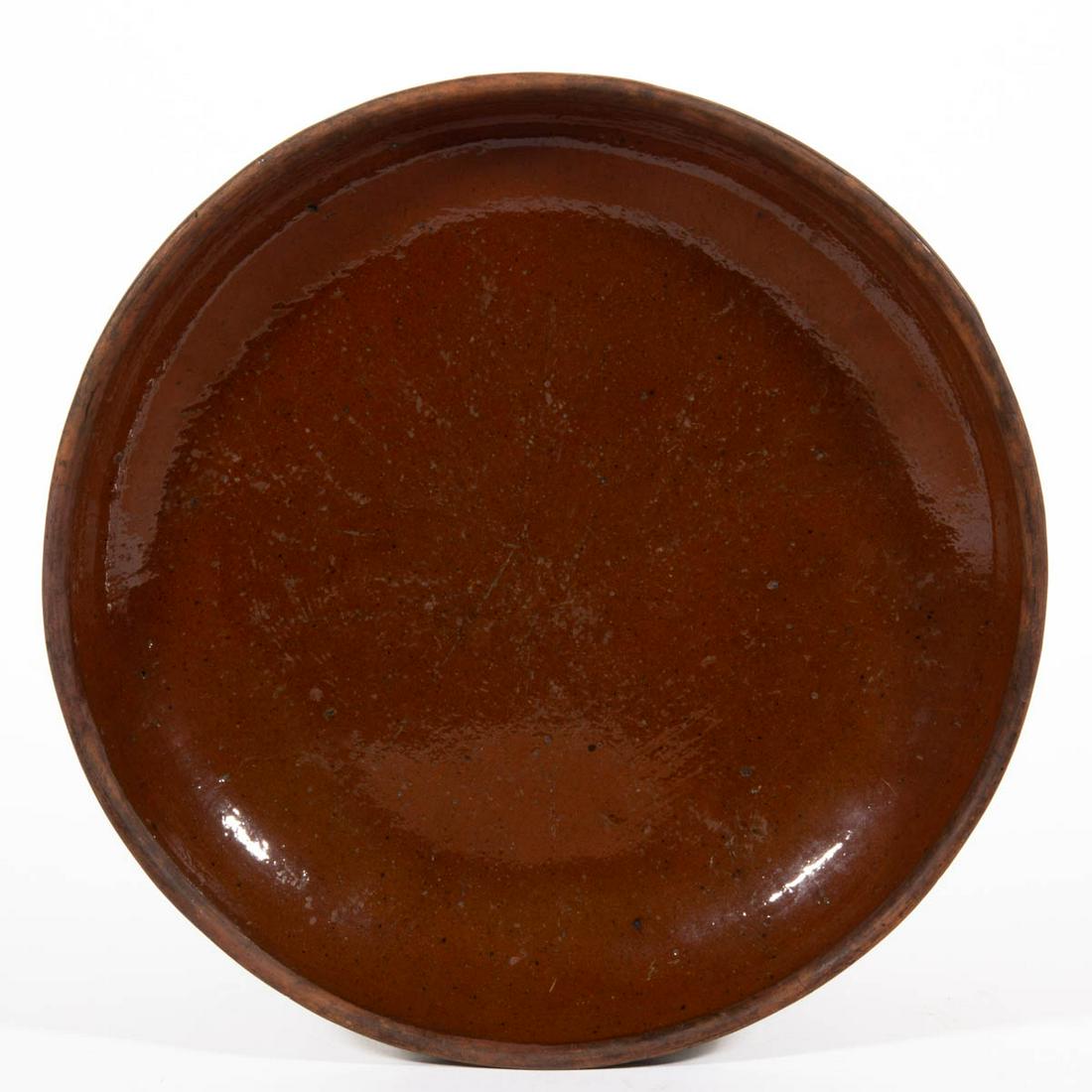 STAMPED "JOHN W. BELL / WAYNESBORO, PA" PENNSYLVANIA: STAMPED "JOHN W. BELL / WAYNESBORO, PA" PENNSYLVANIA EARTHENWARE / REDWARE DISH / PLATE, single lead-glazed, having plain rim. John W. Bell (1828-1895), Waynesboro, PA. Circa 1875. 1 1/2" HOA, 9 3/4"