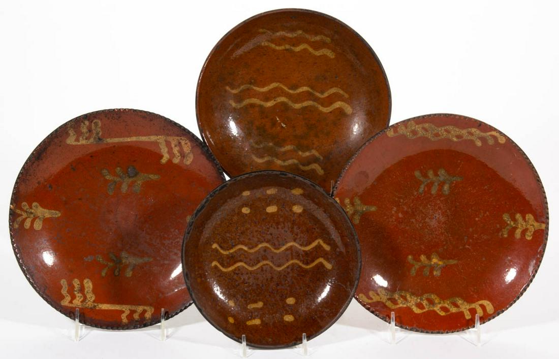 AMERICAN DECORATED EARTHENWARE / REDWARE PLATES, LOT OF: AMERICAN DECORATED EARTHENWARE / REDWARE PLATES, LOT OF FOUR, single lead-glazed, each having yellow-slip trailed decorations, comprising two examples with coggled rim and wavy line and foliate design