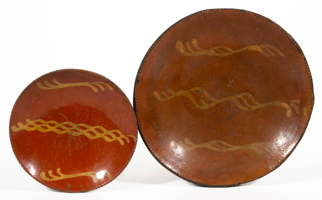 AMERICAN DECORATED EARTHENWARE / REDWARE PLATES, LOT OF: AMERICAN DECORATED EARTHENWARE / REDWARE PLATES, LOT OF TWO, single lead-glazed, each having coggled rim and wavy yellow-slip trailed decorations. First half 19th century. 1 7/8" HOA, 11 5/8" D.Proven