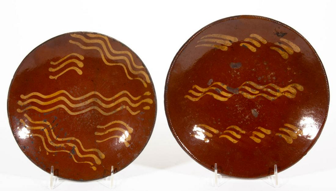 AMERICAN DECORATED EARTHENWARE / REDWARE PLATES, LOT OF: AMERICAN DECORATED EARTHENWARE / REDWARE PLATES, LOT OF TWO, single lead-glazed, each having coggled rim. Yellow-slip trailed wavy line and dash decorations. First half 19th century. 1 3/8" HOA, 10 1/