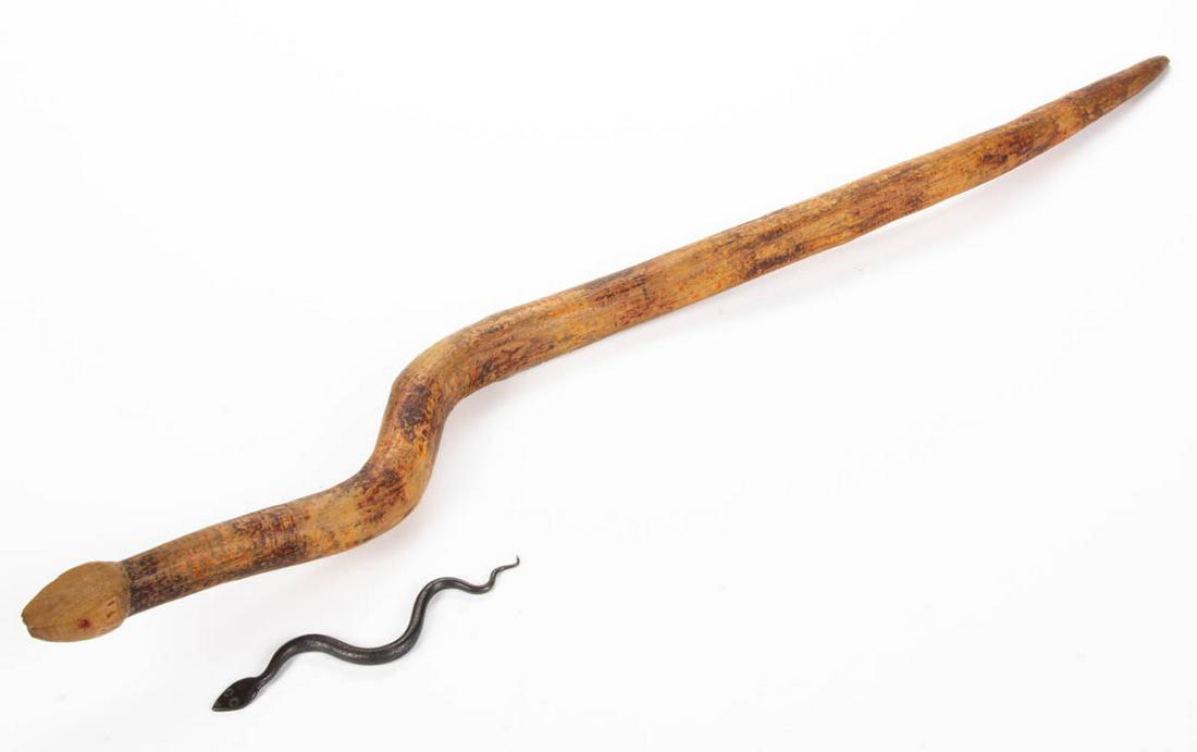 AMERICAN FOLK ART FIGURAL SNAKES, LOT OF TWO: AMERICAN FOLK ART FIGURAL SNAKES, LOT OF TWO, each in sinuous form, comprising a wrought-iron example, and carved and polychrome-painted example with attached note "Attr. Ed Walker / Hillsboro WV carv