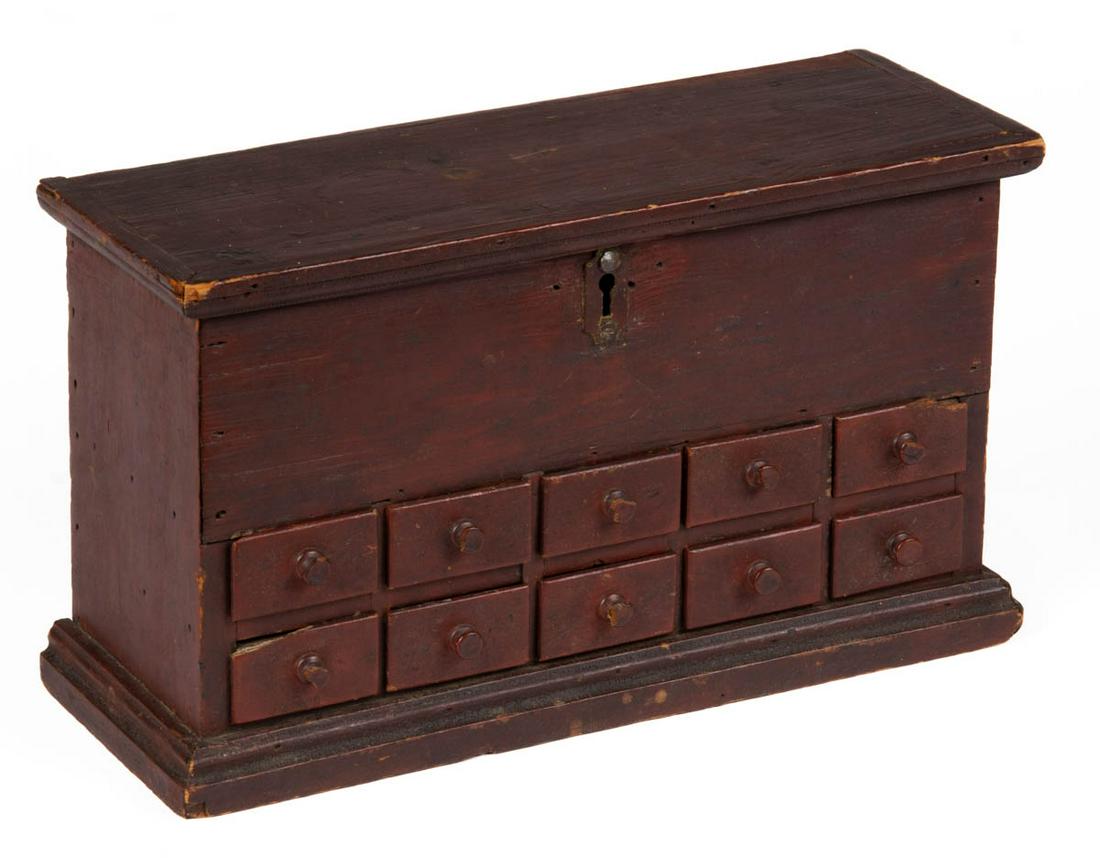 AMERICAN COUNTRY PAINTED PINE MINIATURE SPICE BOX: AMERICAN COUNTRY PAINTED PINE MINIATURE SPICE BOX, hinged rectangular lid with applied molding over concealing an open interior, above ten apothecary drawers, base with applied edged molding. Walnut a