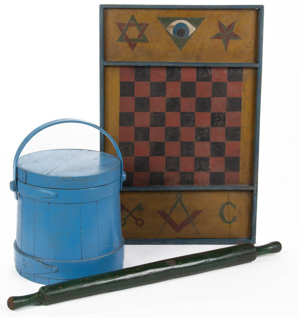 ASSORTED COUNTRY PAINTED ARTICLES, LOT OF THREE: ASSORTED COUNTRY PAINTED ARTICLES, LOT OF THREE, comprising a treen sugar firkin / bucket, rolling pin, an elongated rolling pin with narrow handles, and a gameboard with Masonic decorations and writt