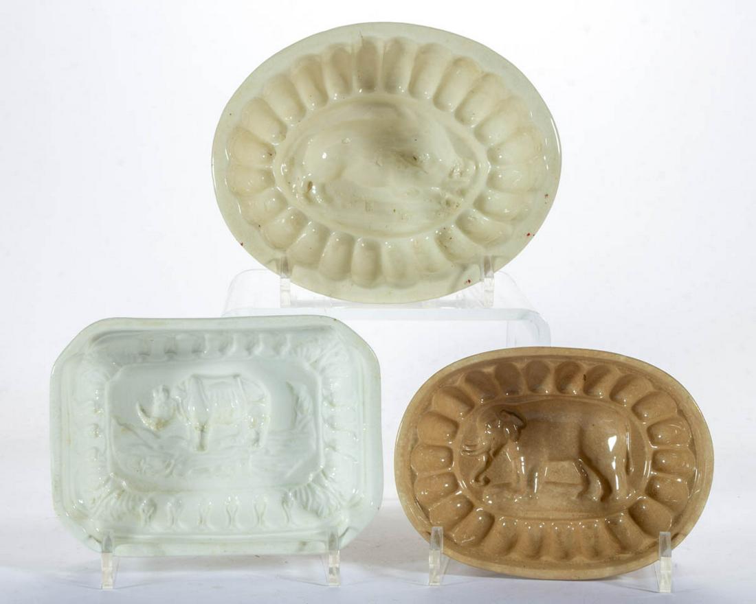 ASSORTED ANIMAL MOTIF CERAMIC FOOD / JELLY MOLDS, LOT: ASSORTED ANIMAL MOTIF CERAMIC FOOD / JELLY MOLDS, LOT OF THREE, comprising two ovoid examples including one depicting a standing elephant with tusks and one featuring a wild boar design, impressed "FE
