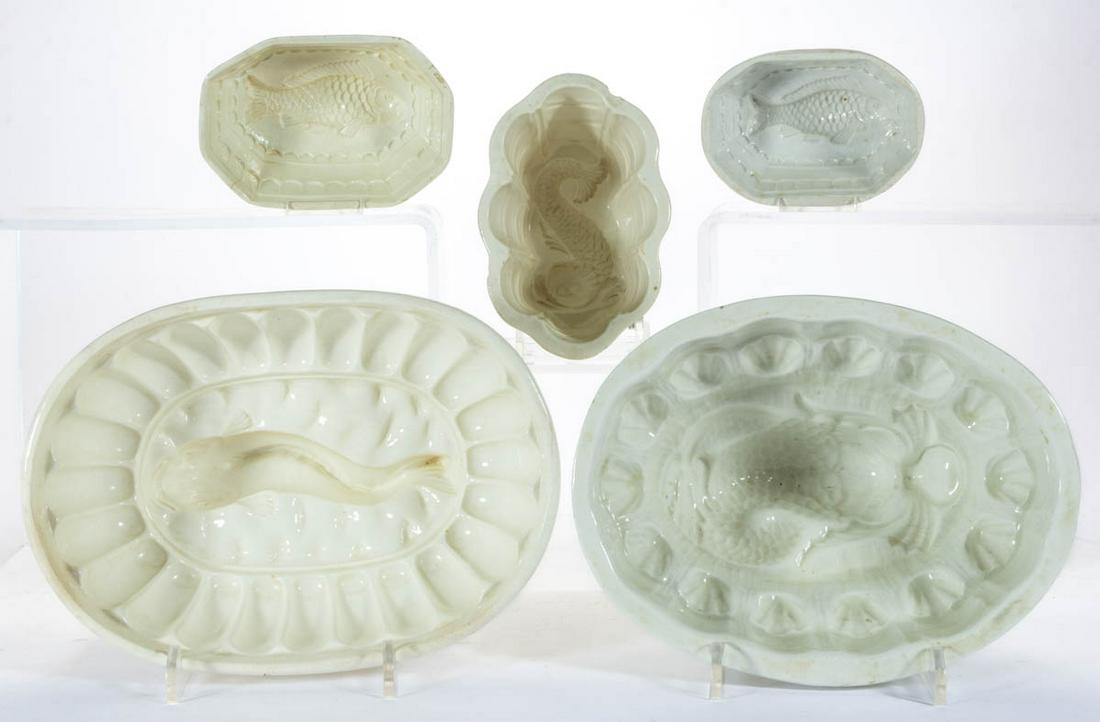 ASSORTED FISH MOTIF CERAMIC FOOD / JELLY MOLDS, LOT OF: ASSORTED FISH MOTIF CERAMIC FOOD / JELLY MOLDS, LOT OF FIVE, comprising two featuring detailed dolphin-type designs, one ovoid form example with a smooth-bodied fish, and two examples with matching de