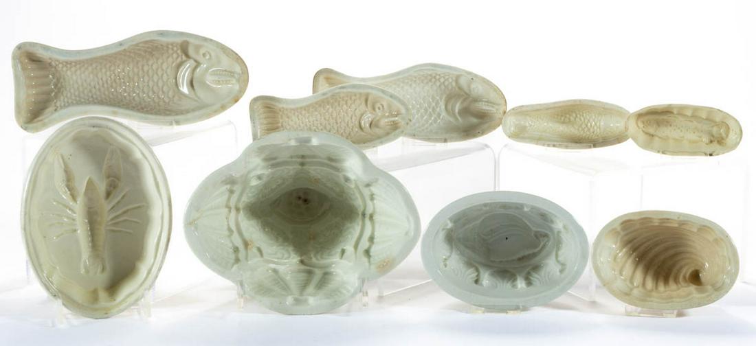 ASSORTED AQUATIC ANIMAL/ SEA MOTIF CERAMIC FOOD / JELLY: ASSORTED AQUATIC ANIMAL/ SEA MOTIF CERAMIC FOOD / JELLY MOLDS, LOT OF NINE, comprising five fish examples including two creamware and a three-piece graduated set, a lobster, two shell forms including