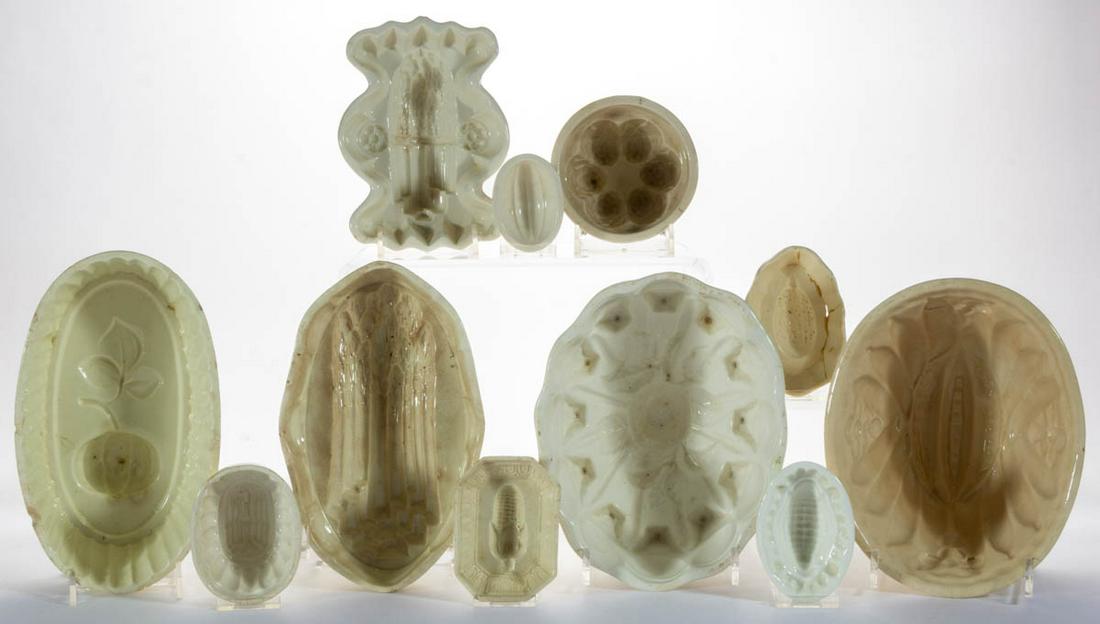 ASSORTED VEGETABLE / FRUIT MOTIF CERAMIC FOOD / JELLY: ASSORTED VEGETABLE / FRUIT MOTIF CERAMIC FOOD / JELLY MOLDS, LOT OF TEN, including designs featuring asparagus spears, melons, and corn including a tri-footed example. Marks include impressed "MINTON"