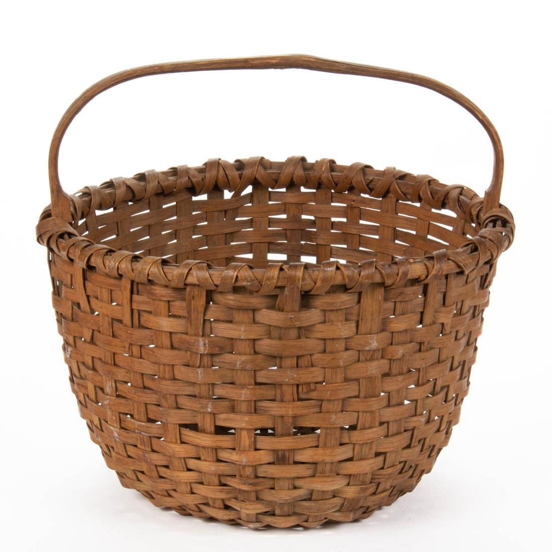 PAGE / ROCKINGHAM CO., SHENANDOAH VALLEY OF VIRGINIA: PAGE / ROCKINGHAM CO., SHENANDOAH VALLEY OF VIRGINIA STAVE-TYPE WOVEN-SPLINT BASKET, white oak, circular form with X-wrapped rim, kick-up to bottom, and arched handle. Dry natural surface. Probably by