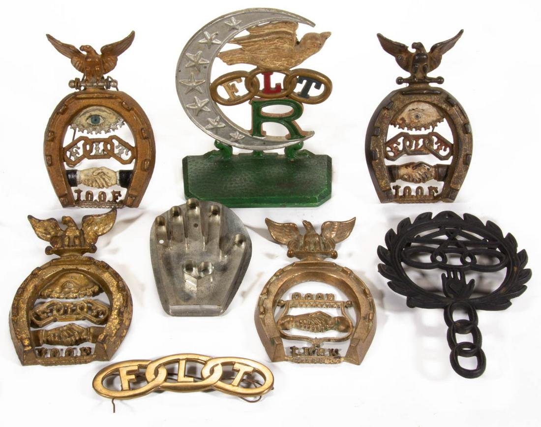 AMERICAN ODD FELLOWS / LODGE CAST-METAL DOORSTOP AND: AMERICAN ODD FELLOWS / LODGE CAST-METAL DOORSTOP AND TRIVETS, LOT OF FIVE, comprising four trivets, three with likely original polychrome-painted surface, one example is brass, and a Rebekah door stop