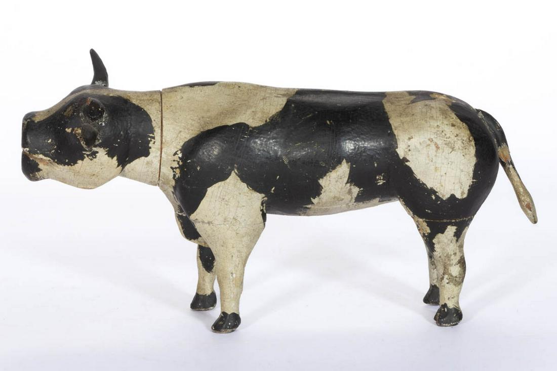 MID-ATLANTIC FOLK ART CARVED AND PAINTED FIGURE OF A: MID-ATLANTIC FOLK ART CARVED AND PAINTED FIGURE OF A HOLSTEIN, segmented construction, with applied tail, horns, and ears. Retains outstanding, likely original, black- and white-painted surface. Fourt