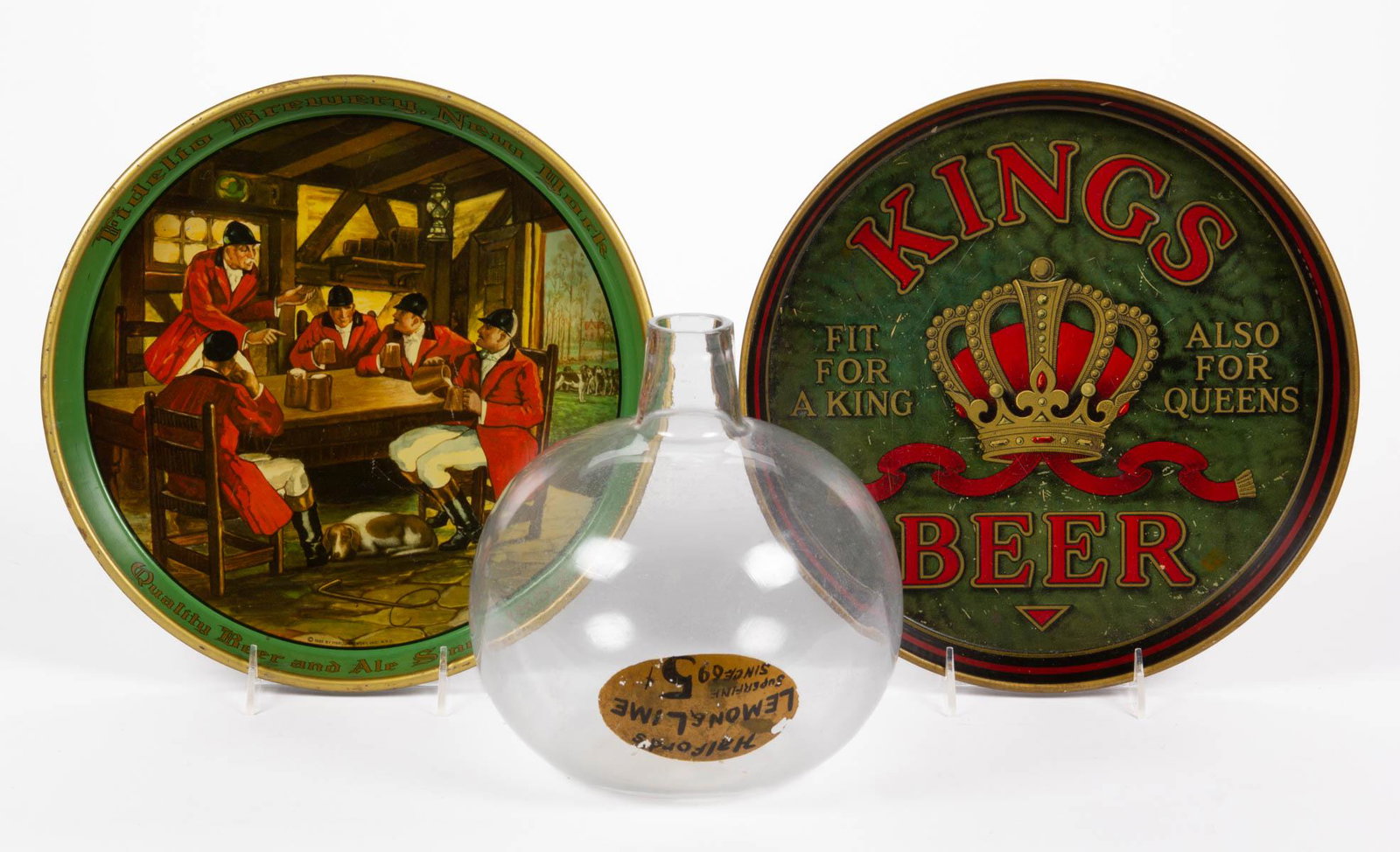 VINTAGE BEER ADVERTISING SERVING TRAYS, LOT OF TWO: VINTAGE BEER ADVERTISING SERVING TRAYS, LOT OF TWO, for "KINGS BEER" and "FIDELIO" breweries. Together with "Halford's Lemon & Lime" clear glass container. Fidelio dated 1935. Kings 12" D. Provenance: