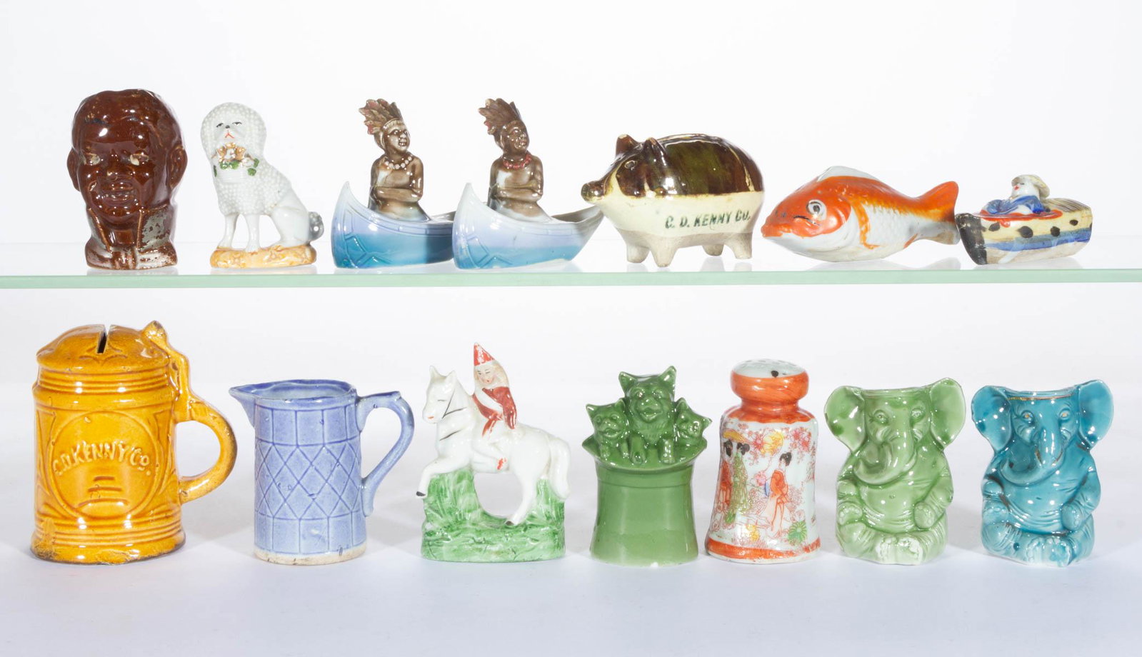 ASSORTED VINTAGE C. D. KENNY BISQUE ADVERTISING FIGURAL: ASSORTED VINTAGE C. D. KENNY BISQUE ADVERTISING FIGURAL ARTICLES, LOT OF 14, including a sitting poodle holding a flower basket, a goldfish, seven toothpick / match holders including two sitting eleph