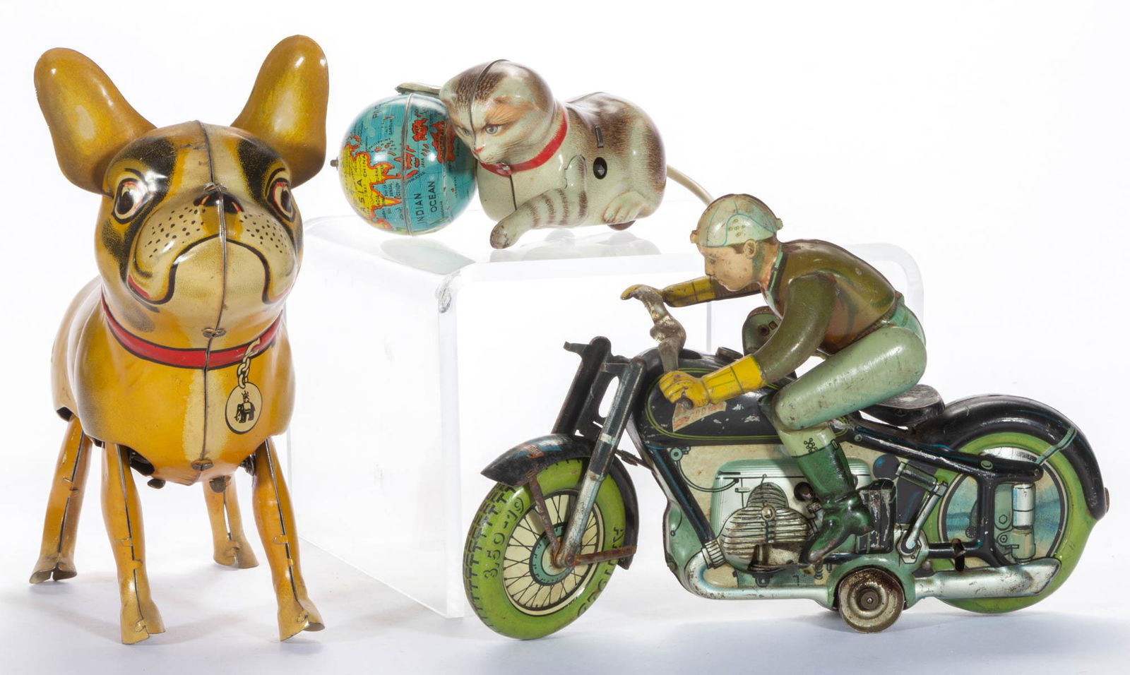 VINTAGE U.S. ZONE GERMAN LITHOGRAPHED TIN WIND-UP TOYS,: VINTAGE U.S. ZONE GERMAN LITHOGRAPHED TIN WIND-UP TOYS, LOT OF THREE, comprising a French bulldog toy by Blomer & Schuler, a "Roll Over" cat toy with globe probably by Kohler, and an Arnold "Mac 700"