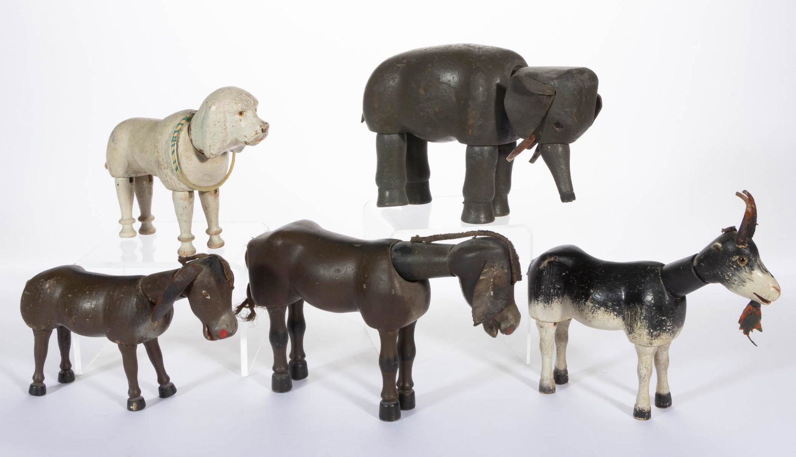 SCHOENHUT CIRCUS TOY ANIMALS, LOT OF FIVE: SCHOENHUT CIRCUS TOY ANIMALS, LOT OF FIVE, each having wooden jointed body and polychrome-painted finishes, comprising two donkeys, a poodle dog, a goat with glass eyes, and an elephant with glass eye