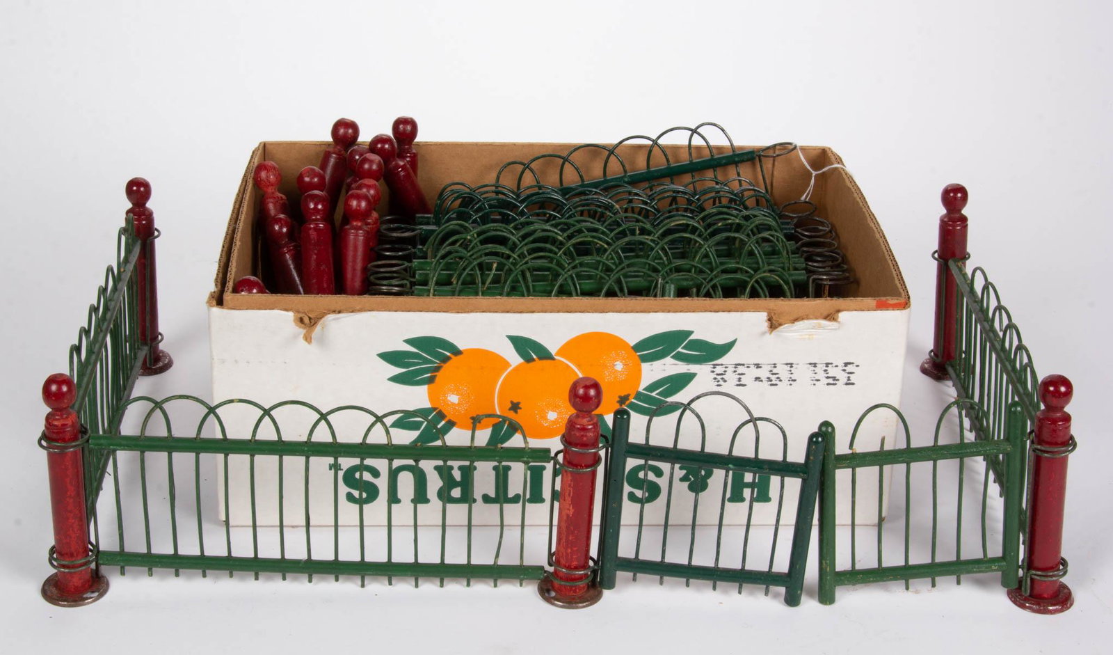 E.W. DRAKE MFG. CO. HOLIDAY / CHRISTMAS TREE FENCE, TWO: E.W. DRAKE MFG. CO. HOLIDAY / CHRISTMAS TREE FENCE, TWO SETS, 43 total pieces, each set made of wood and metal, having green-painted fencing and red-painted posts. Each post metal base marked for E.W.