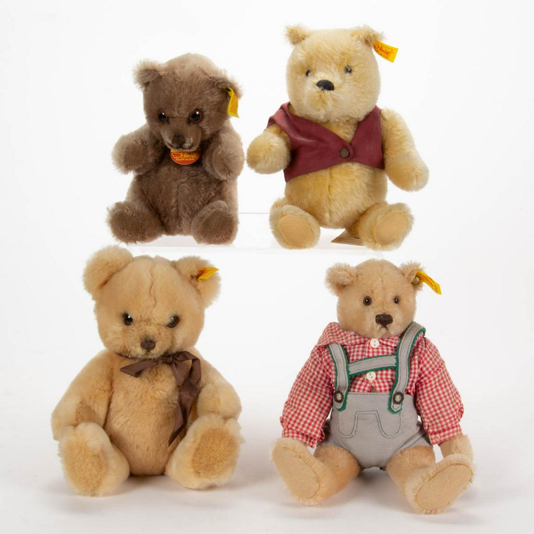 GERMAN STEIFF STUFFED TEDDY BEARS, LOT OF FOUR: GERMAN STEIFF STUFFED TEDDY BEARS, LOT OF FOUR, each with brown or black eyes and black floss noses, comprising three mohair examples, including an unjointed Manschli example with yellow tag marked "0