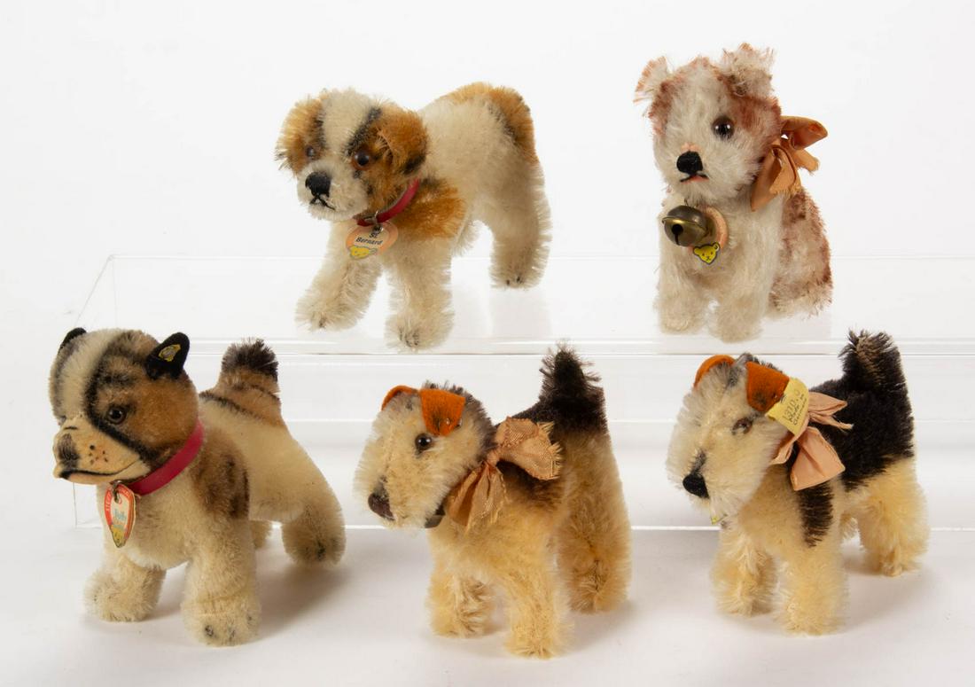 VINTAGE GERMAN "ARCO" STEIFF STUFFED DOGS, LOT OF FIVE: VINTAGE GERMAN "ARCO" STEIFF STUFFED DOGS, LOT OF FIVE, black and tan mohair, each with brown eyes, comprising two Terry examples with pink silk bows, one with yellow tag marked "1310.0" and retaining