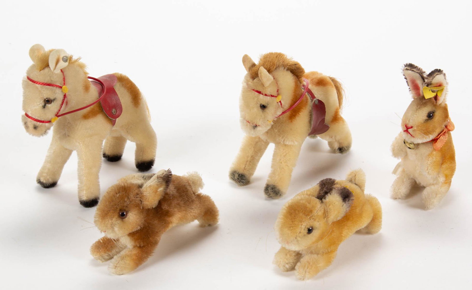 VINTAGE GERMAN STEIFF STUFFED ANIMALS, LOT OF FIVE: VINTAGE GERMAN STEIFF STUFFED ANIMALS, LOT OF FIVE, mohair in tan/brown and spotted tones, each with brown eyes, comprising three rabbits, including two running examples, one with yellow tag marked "1