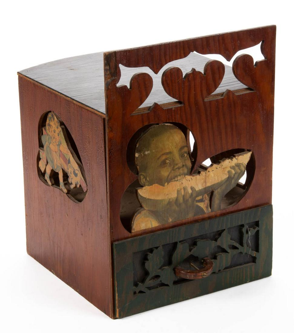 FOLK ART BLACK AMERICANA WOODEN BOX: FOLK ART BLACK AMERICANA WOODEN BOX, featuring single drawer and hinged lid, with decoupage including a young man eating a watermelon. First half 20th century. 16" HOA, 11" W, 11 1/2" D.Provenance: Th