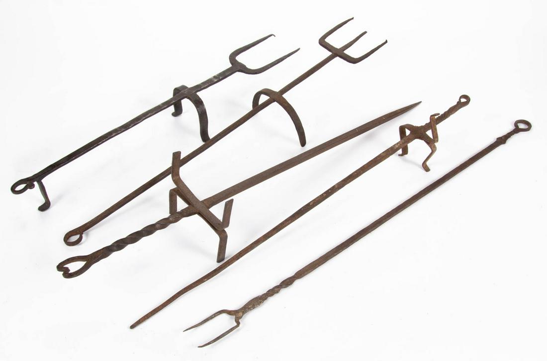 ASSORTED WROUGHT-IRON HEARTH UTENSILS, LOT OF FIVE: ASSORTED WROUGHT-IRON HEARTH UTENSILS, LOT OF FIVE, comprising two standing toasting forks, each with arch-form legs and ring extensions, one example with double tines and remaining with triple tines;
