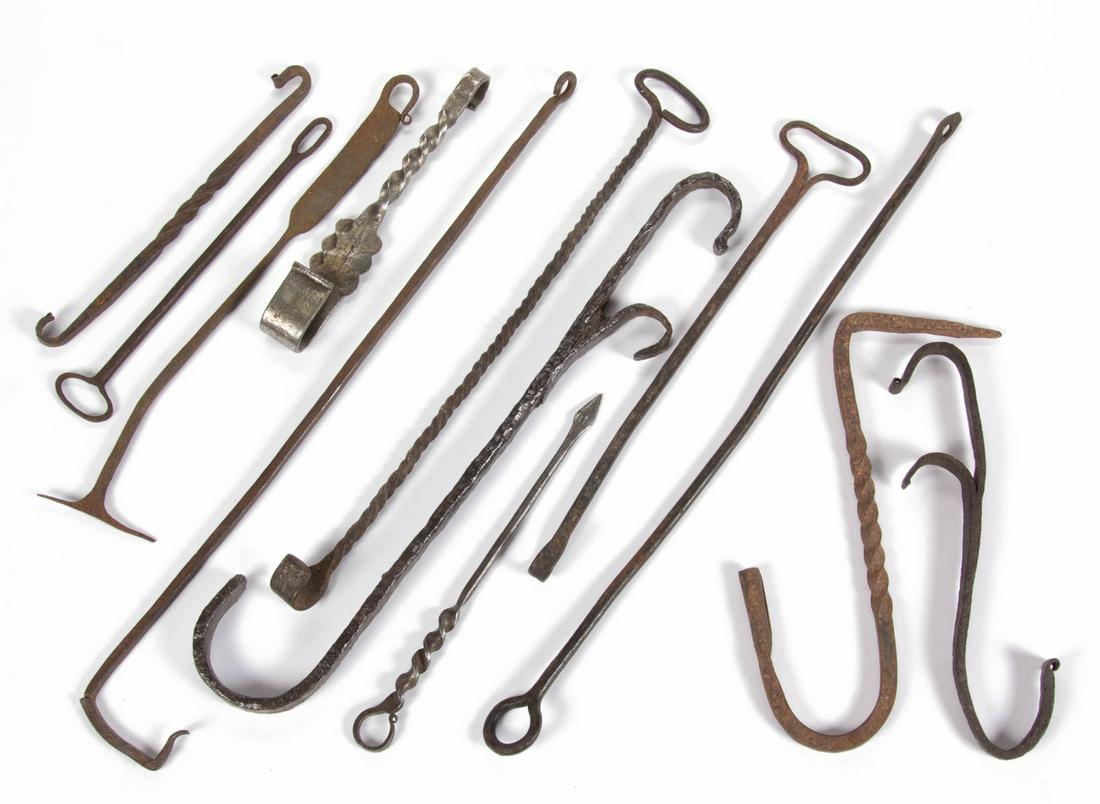 ASSORTED WROUGHT-IRON HEARTH AND OTHER HOOKS, LOT OF 12: ASSORTED WROUGHT-IRON HEARTH AND OTHER HOOKS, LOT OF 12, various forms with some having spiraling shafts, including an example with a single-socket candle holder, a double-ended example and two exampl