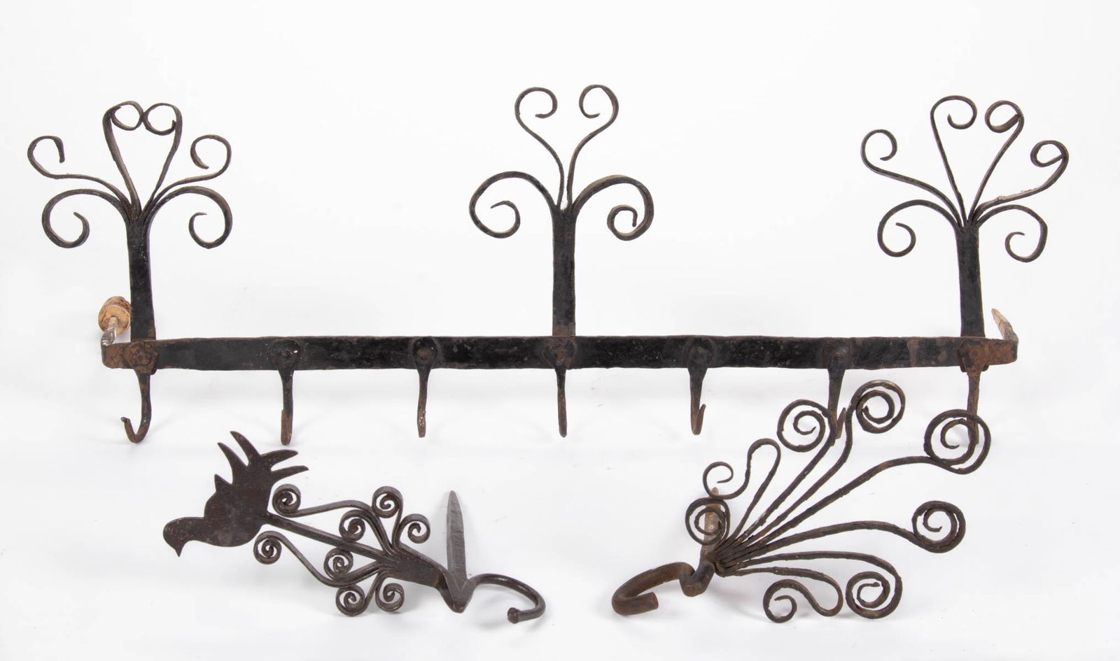 ASSORTED WROUGHT-IRON FIGURAL ORNAMENTAL WALL RACKS,: ASSORTED WROUGHT-IRON FIGURAL ORNAMENTAL WALL RACKS, LOT OF THREE, comprising two examples with a single spike construction over a hook, each with a spray of curled tips and including one with a bird