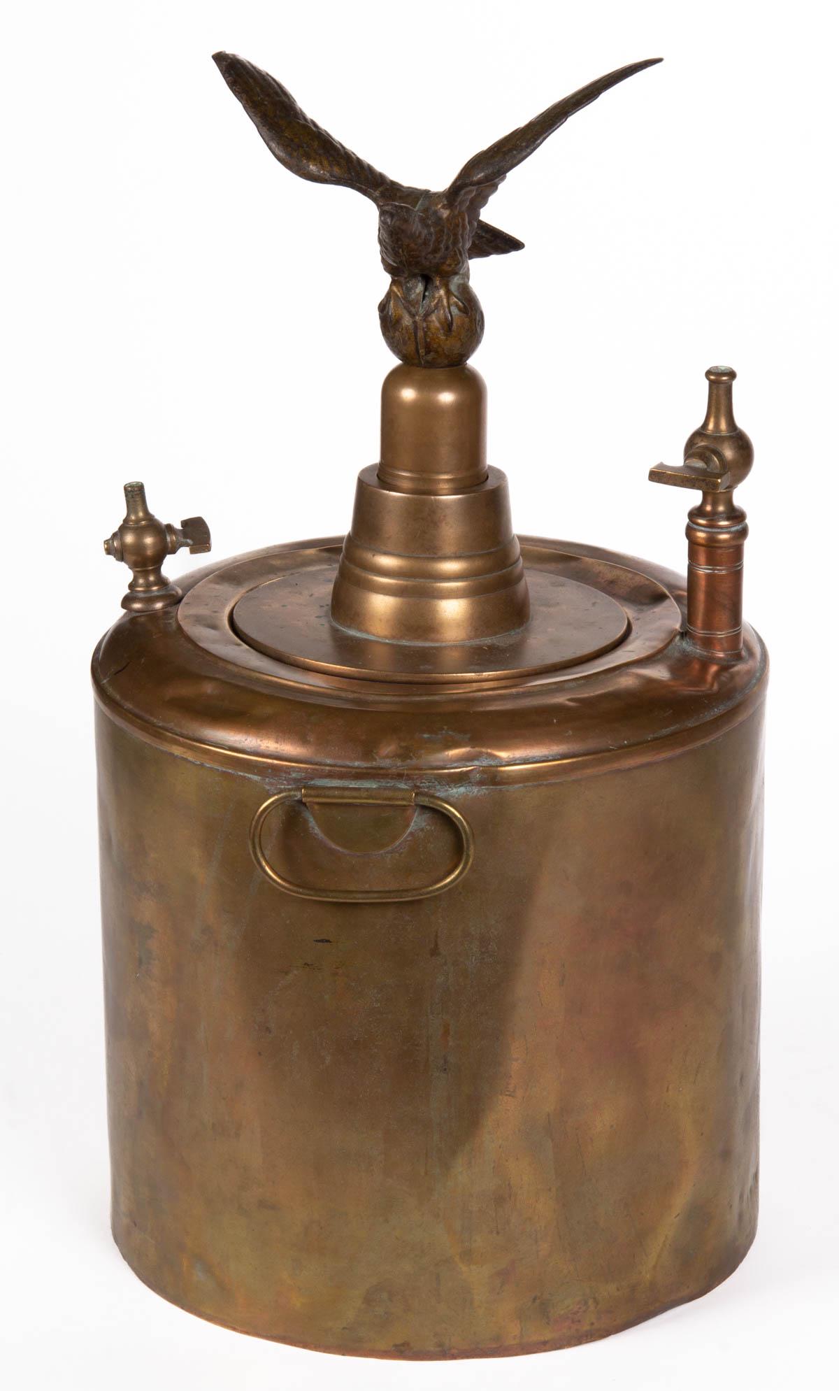 BRASS AND COPPER STEAM BOILER POT WITH VALVES: BRASS AND COPPER STEAM BOILER POT WITH VALVES, cylinder form with double handles, interior fitted with a 3 3/4" D cylinder with crossbars at the top for attaching the caps and a figural eagle with spr