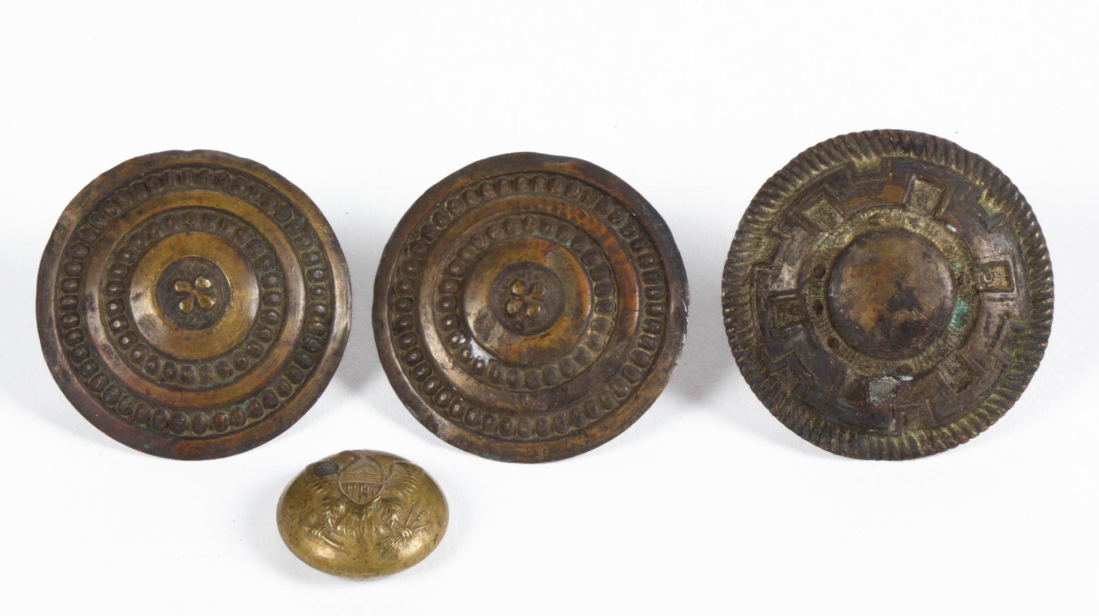 CIVIL WAR ERA BRASS ARTICLES, LOT OF FOUR: CIVIL WAR ERA BRASS ARTICLES, LOT OF FOUR, comprising a Union General Service uniform button, and three civilian horse bridal rosettes with lead-filled backs and loops. Circa 1865. 3/4" to 1 5/8" D. P