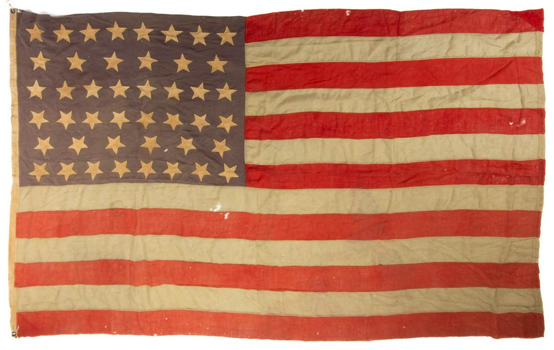 44-STAR AMERICAN NATIONAL WYOMING STATEHOOD FLAG: 44-STAR AMERICAN NATIONAL WYOMING STATEHOOD FLAG, machine- and hand-sewn wool bunting, the denim blue canton featuring single-appliqued cotton linen five-pointed stars arranged in five rows, cut-out t