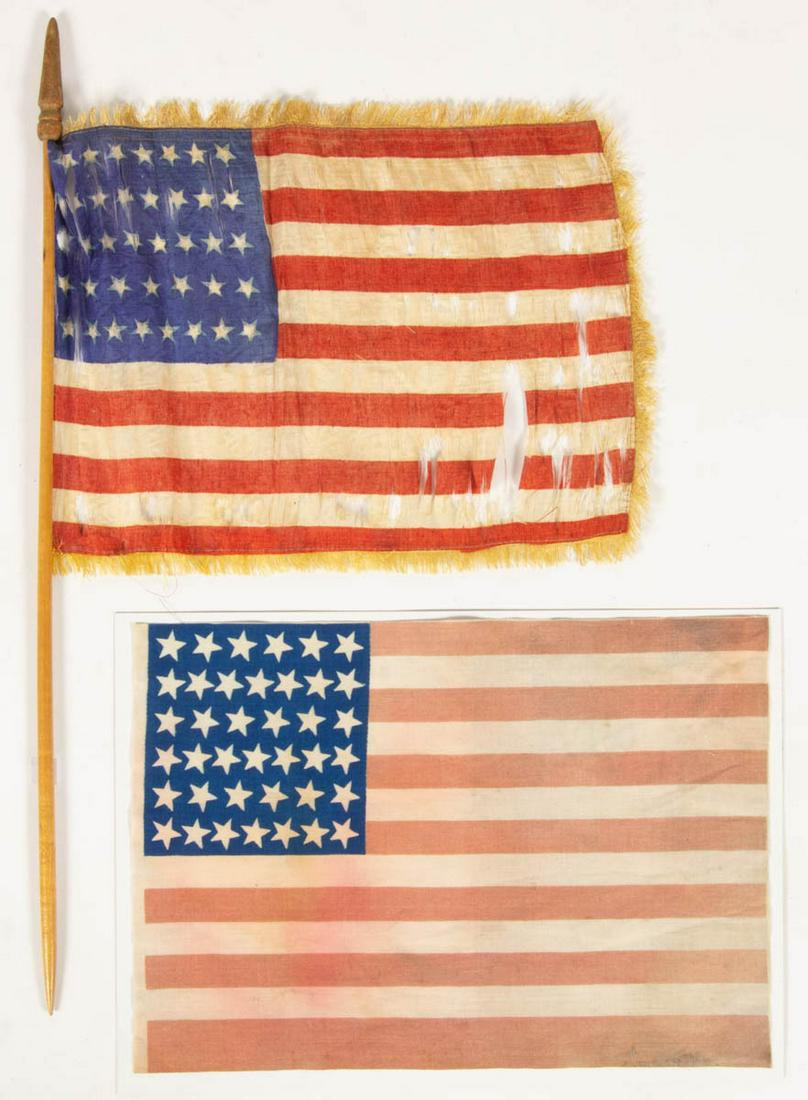 39-STAR UNOFFICIAL AMERICAN NATIONAL NORTH: 39-STAR UNOFFICIAL AMERICAN NATIONAL NORTH DAKOTA-STATEHOOD PRINTED PARADE FLAG, glazed cotton linen, Unframed. Together with a small printed silk 39-star parade flag with gold fringe and likely origi