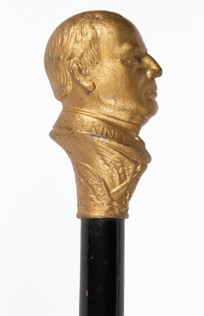 PRESIDENT WILLIAM MCKINLEY CAMPAIGN CANE / WALKING: PRESIDENT WILLIAM MCKINLEY CAMPAIGN CANE / WALKING STICK, featuring bust of William McKinley embossed "OUR NEXT PRESIDENT Wm MCKINLEY". 1900. 35 3/4" L.Provenance: From the John & late Evelyn Teague c