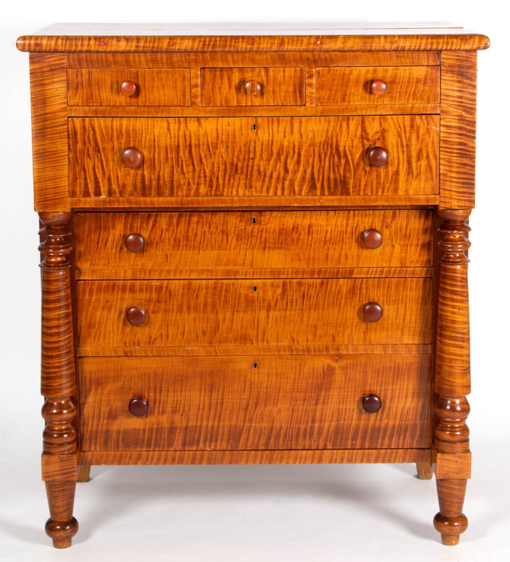 INDIANA EMPIRE TIGER MAPLE CHEST OF DRAWERS: INDIANA EMPIRE TIGER MAPLE CHEST OF DRAWERS, rectangular one-board top over three overhanging short drawers above overhanging full-length drawer, over three graduated drawers, flanked by columns, the 