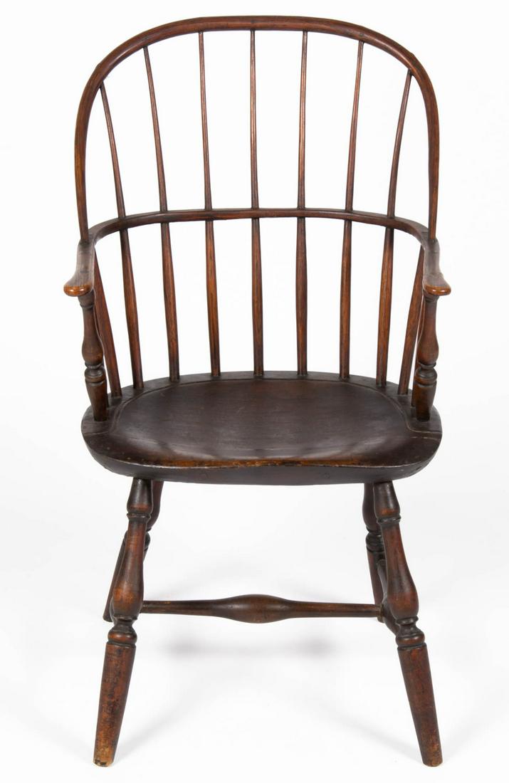 AMERICAN COUNTRY BOWBACK WINDSOR ARMCHAIR: AMERICAN COUNTRY BOWBACK WINDSOR ARMCHAIR, continuous arm with seven spindle back, shaped seat, and turned legs joined with H-form stretcher. Old refinished surface with warm color. Fourth quarter 18t