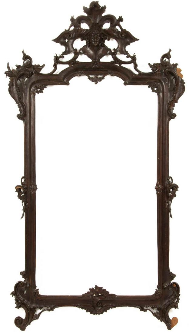 ROCOCO REVIVAL CARVED WOODEN LOOKING GLASS / WALL: ROCOCO REVIVAL CARVED WOODEN LOOKING GLASS / WALL MIRROR FRAME, done in the style of Matthias Lock. Retains likely original surface with warm color. Fourth quarter 19th century. 65" HOA, 36" WOA. Prov