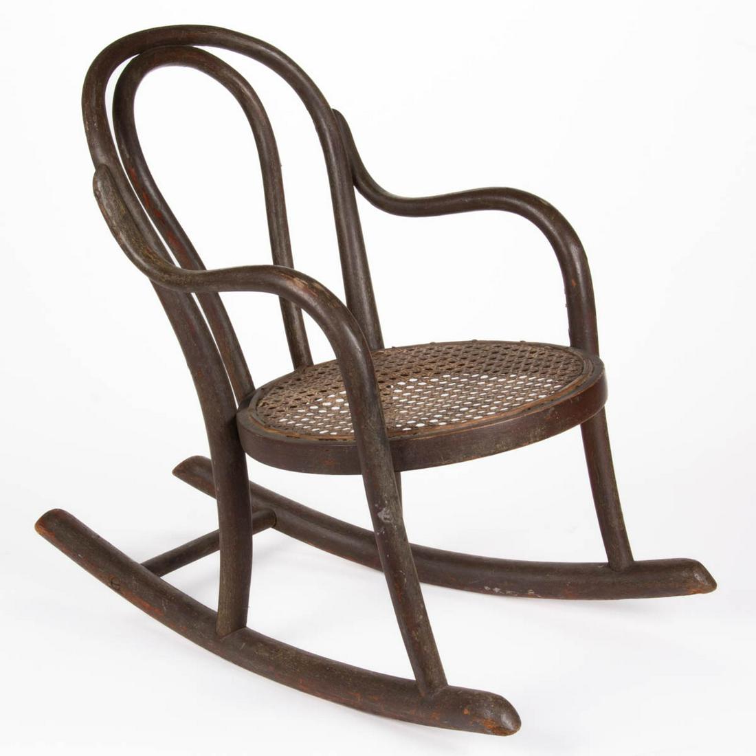 THONET BENTWOOD CHILD'S ARM ROCKER: THONET BENTWOOD CHILD'S ARM ROCKER, retaining partial original label to underside of likely original seat. Retains an old painted surface. Circa 1885. 20" HOA, 10" H seat, 12" D seat. Shipping Note: I