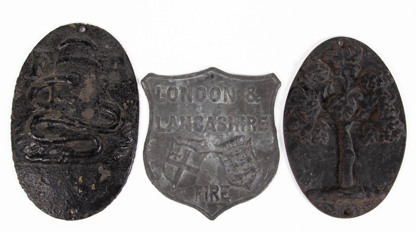ASSORTED CAST-IRON AND CAST-LEAD FIRE INSURANCE MARKS /: ASSORTED CAST-IRON AND CAST-LEAD FIRE INSURANCE MARKS / PLAQUES, LOT OF THREE, each with mounting holes/hole, two cast-iron examples comprising an ovoid and convex form example with original black pai