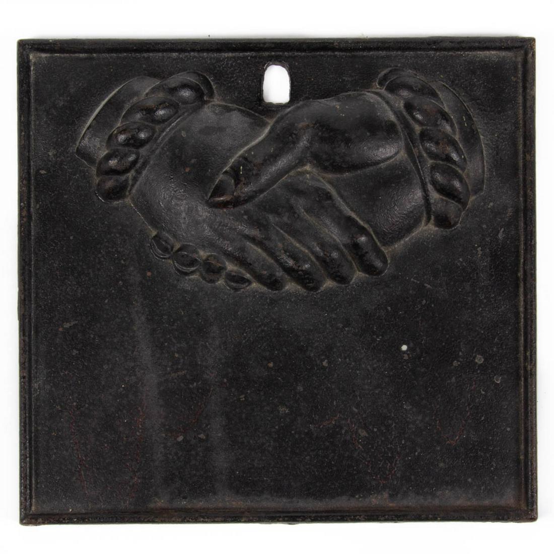 CAST-IRON BALTIMORE EQUITABLE SOCIETY FIRE INSURANCE: CAST-IRON BALTIMORE EQUITABLE SOCIETY FIRE INSURANCE MARK / PLAQUE, black paint, square form with rolled border and hanging opening, clasped hands with each cuff having six links. Mid 19th century. 10