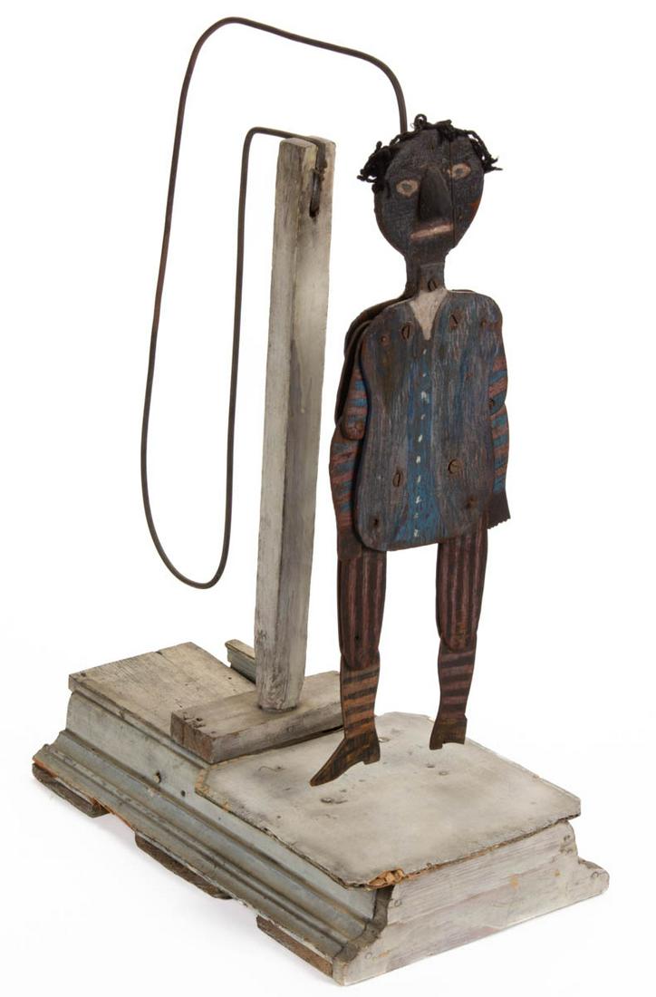 FOLK ART BLACK AMERICANA PAINT-DECORATED DANCING TOY: FOLK ART BLACK AMERICANA PAINT-DECORATED DANCING TOY, mixed-wood construction with iron suspension rod and cardboard dancing surface. Retains likely original polychrome painted surface. Circa 1920. 22