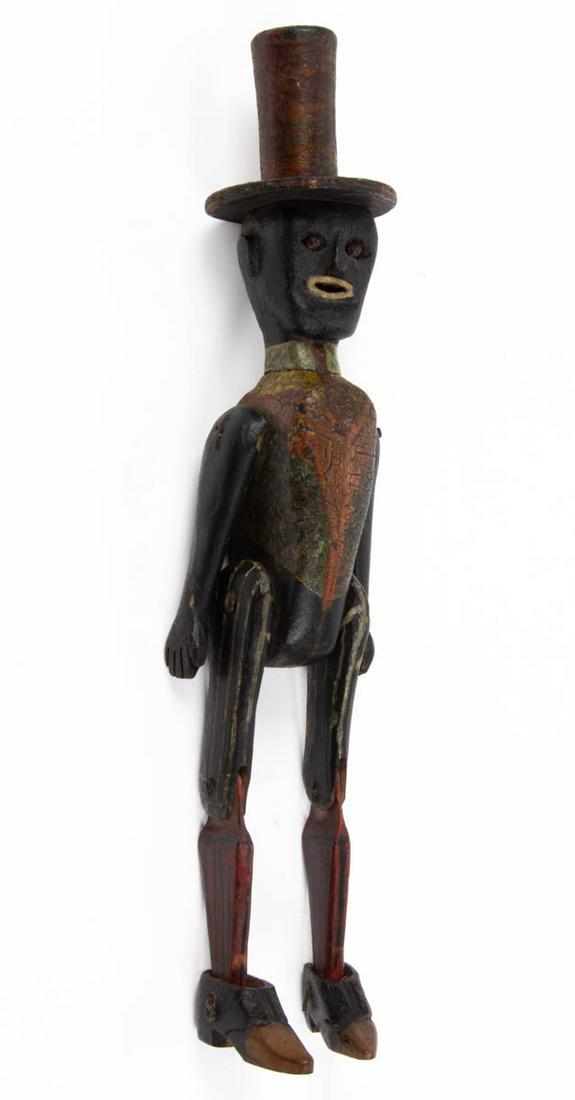 AMERICAN FOLK ART CARVED AND PAINTED WHIMSY / FIGURE: AMERICAN FOLK ART CARVED AND PAINTED WHIMSY / FIGURE, jointed, depicting a figure wearing a top hat. Retains likely original polychrome painted surface. First quarter 20th century. 13" H. Provenance: 