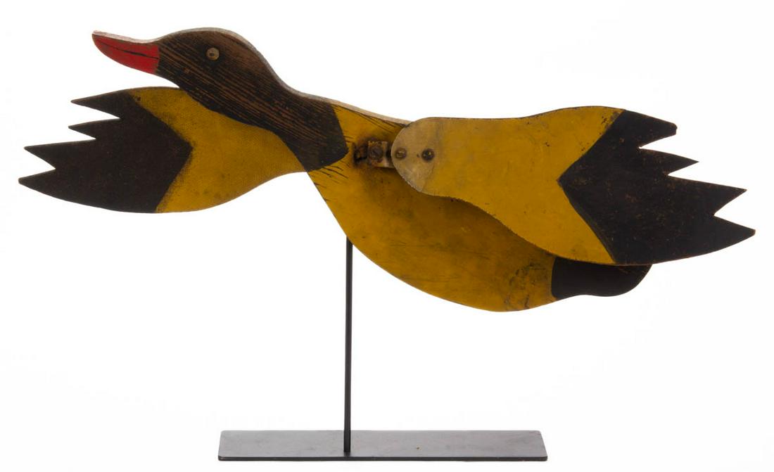 AMERICAN FOLK ART PAINTED DUCK WHIRLIGIG: AMERICAN FOLK ART PAINTED DUCK WHIRLIGIG, featuring rotating Masonite wings and applied button eyes, retains original yellow-, black-, and red-painted surface. Presented on a custom iron stand. Circa