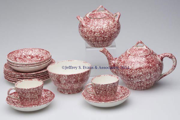 CHILD'S SPATTERWARE 16-PIECE TEA SET: CHILD'S SPATTERWARE 16-PIECE TEA SET, red and white, comprising a teapot, sugar bowl, waste bowl, two cups, five saucers, and six plates, unmarked. Second half 19th century. Teapot 4 1/2" HOA, 4 1/2"