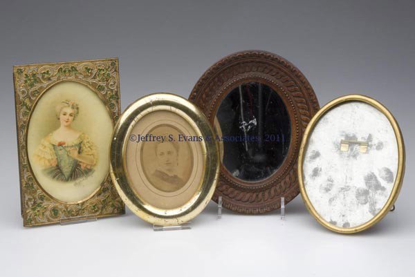 FOUR ASSORTED DIMINUTIVE PICTURE FRAMES: FOUR ASSORTED DIMINUTIVE PICTURE FRAMES, comprising an Italian carved wood example with mirror, an oval gilt-wood example, and two gilt-metal examples. Mid 19th to first quarter 20th century. 5 3/8" x