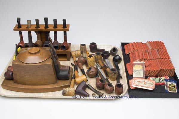 ASSORTED UNCOUNTED LOT OF SMOKING ACCESSORIES: ASSORTED UNCOUNTED LOT OF SMOKING ACCESSORIES, comprising a variety of pipes including leather covered and briar, two pipe racks, and a group of vintage packs of rolling papers. 19th and 20th centurie