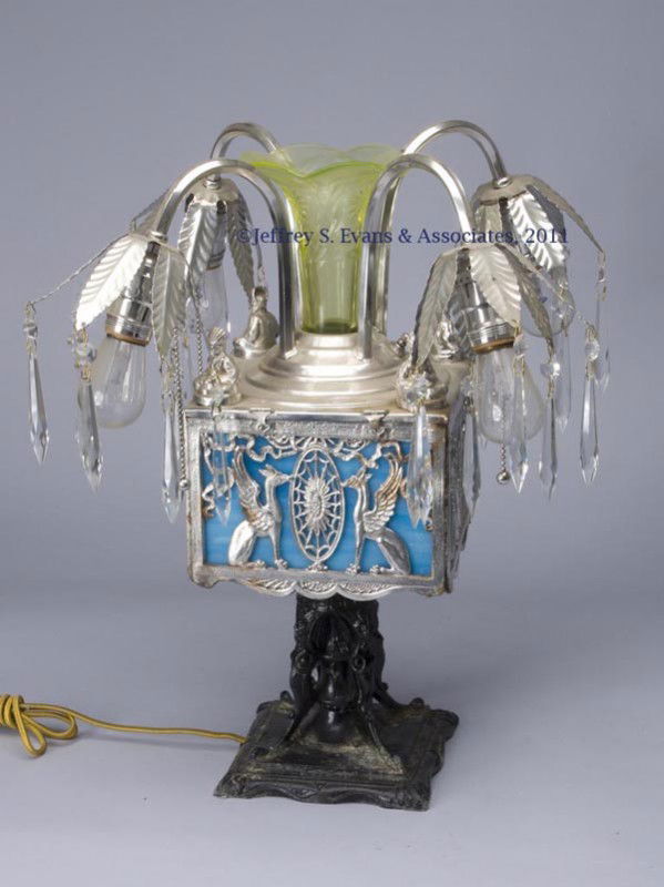 MILLER LAMP CO. EGYPTIAN REVIVAL TABLE LAMP: MILLER LAMP CO. EGYPTIAN REVIVAL TABLE LAMP, chrome-plated and painted metal, hinged-top box with four protruding sockets and interior slag glass panels, vaseline glass vase insert of unknown associat